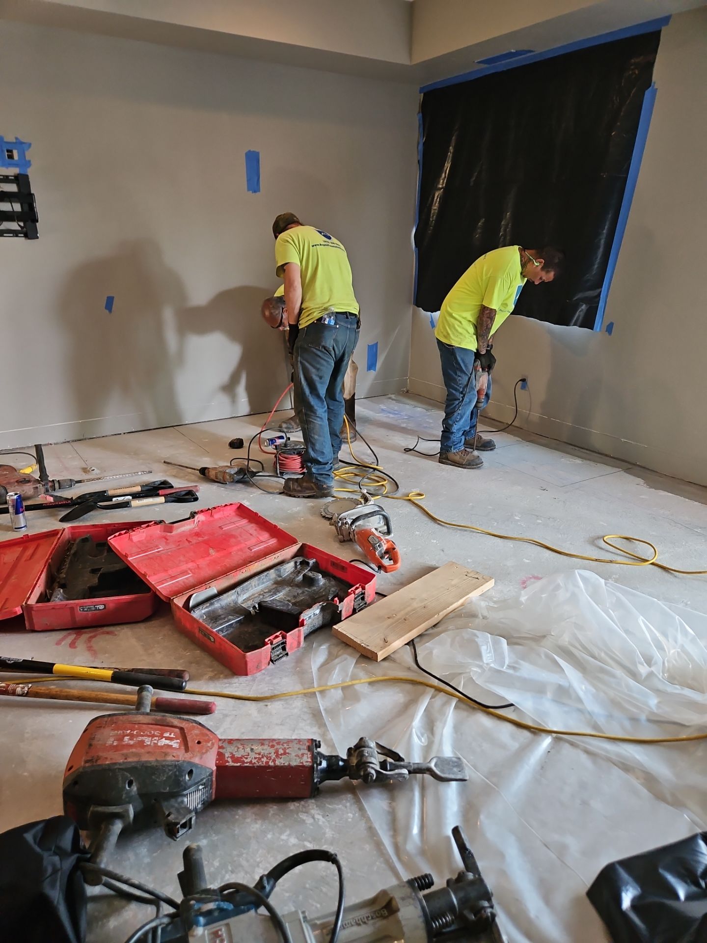 Crew sealing the rim joist and penetrations inside a crawl space