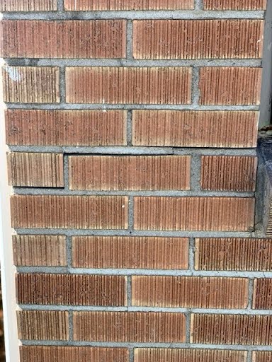 Shifted brick courses showing movement at a foundation corner