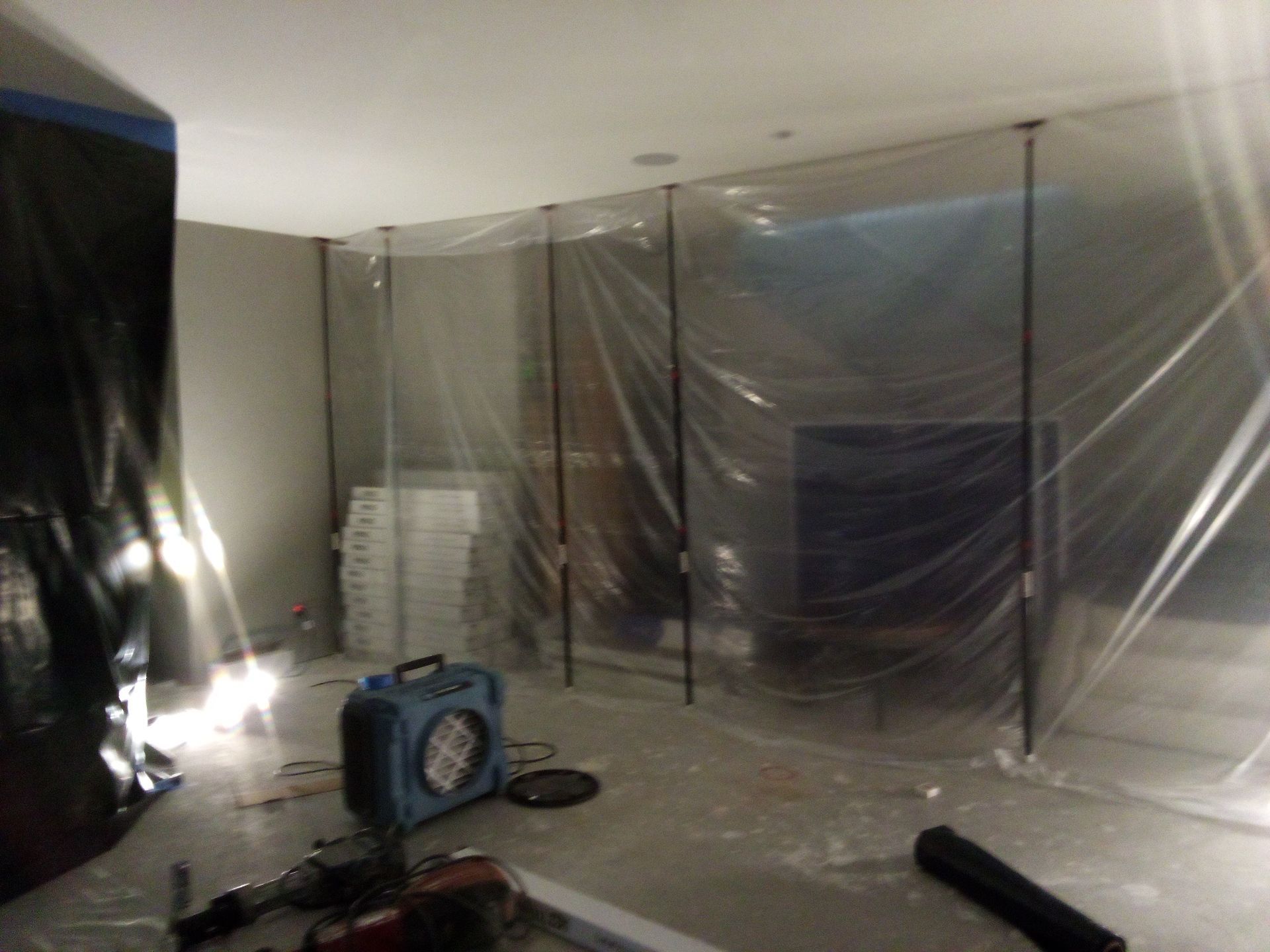 Crew staging liner materials inside a sealed crawl space