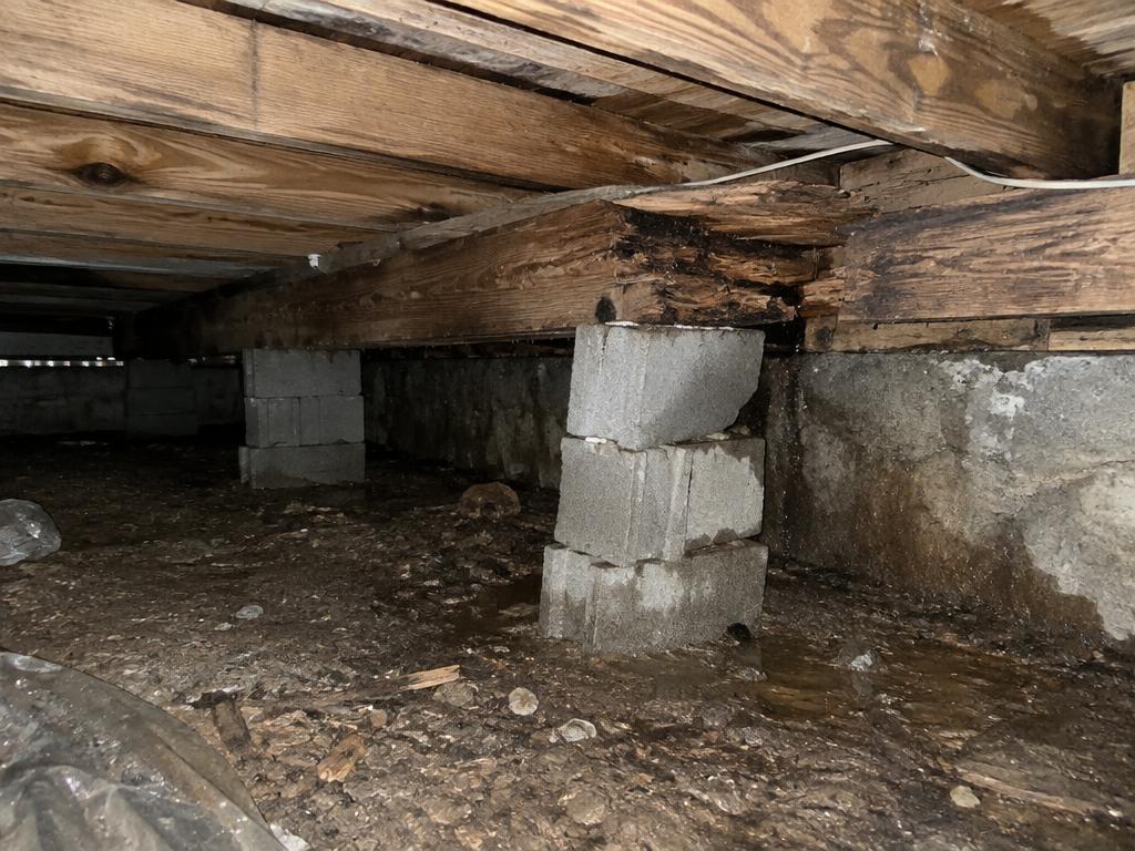 Sagging, rotting crawl space beam on a failing block support